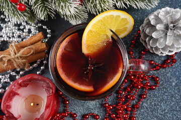 Christmas mulled red wine with spices and fruits on a table. Traditional hot drink at Christmas time
