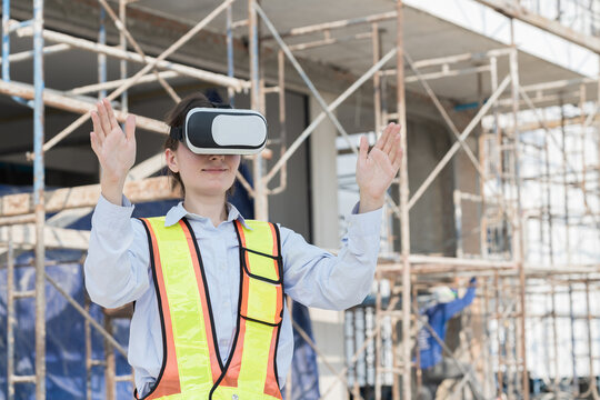 Woman builder construction using virtual reality headset at construction site. Foreman woman construction working and wearing virtual reality headset for inspecting work at construction site