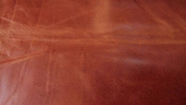 A beautiful rich caramel coloured piece of leather with texture and patina ready to be used to create leather goods in a small artisan workshop