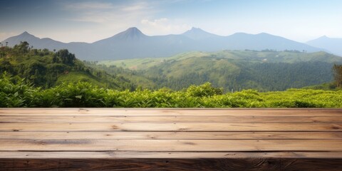 Wooden table in front of mountain view with tea plantation background, space for text.