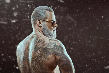 muscular man under snow