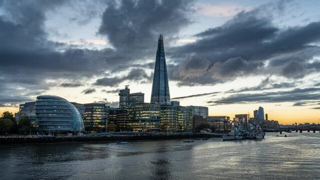 Day to night Time lapse of The Shard london bridge area with glass office building riverbank in high street london, United Kingdom