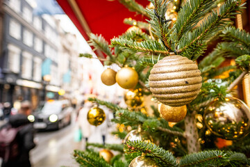 Close focus of Christmas decorations on busy city shopping street scene