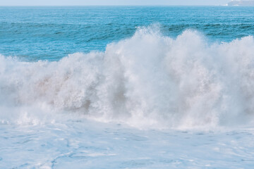 Wave splashing close-up. Crystal clear sea water, in the ocean in San Francisco Bay, blue water, pastel colors.