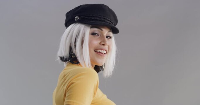 Happy, woman and cool fashion in studio, grey background and mockup with creative style. Smile, clothes or portrait of model in retro outfit and hat with confidence, pride and unique aesthetic