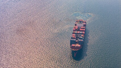 Aerial view container freight ship carrying container box for import and export business logistic and transportation by container ship.