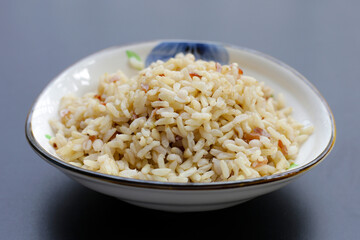 Cooked brown rice on dark background.