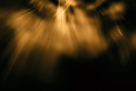 Blur colorful gold crystal light leaks on black background. Defocused abstract red and orange retro film lens flare bokeh analog photo overlay or screen filter effect. Glow Vintage prism warm colors