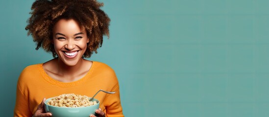 Smiling African American woman with braids enjoying healthy whole grain cereal.