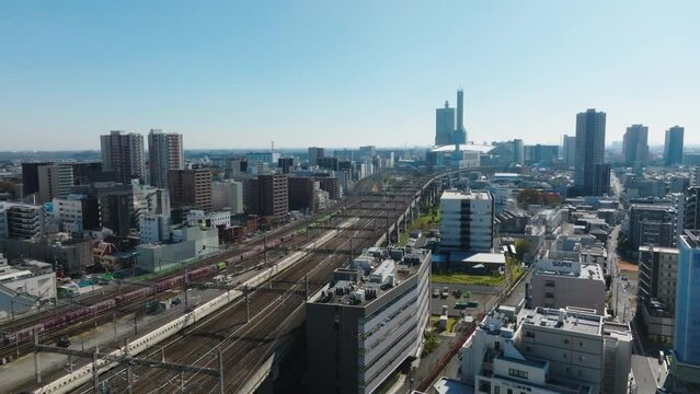 Flying Towards Omiya Station Drone with Shinkansen and Freight Train on Track