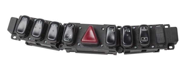 Black plastic block of car control panel with red emergency stop button for signal lights, spare part on a white isolated background in a photo studio for sale and installation in a auto service.