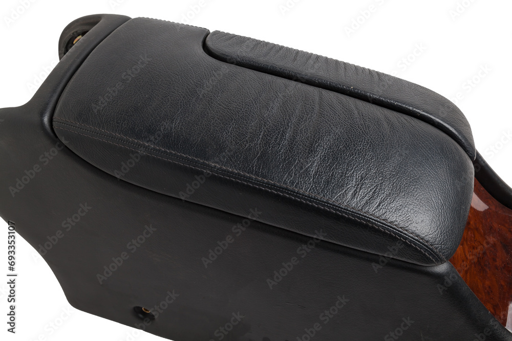 Poster Plastic element of car interior is covered in black leather - armrest or a glove compartment - spare part with air conditioning holes on a white background. Catalog for site.