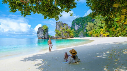 a couple of men and women on the beach of Koh Hong during vacation in Thailand, a tropical white...