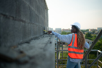 Young female engineer or architect working on construction site