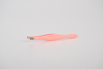 Pink hair tweezers isolated on white background