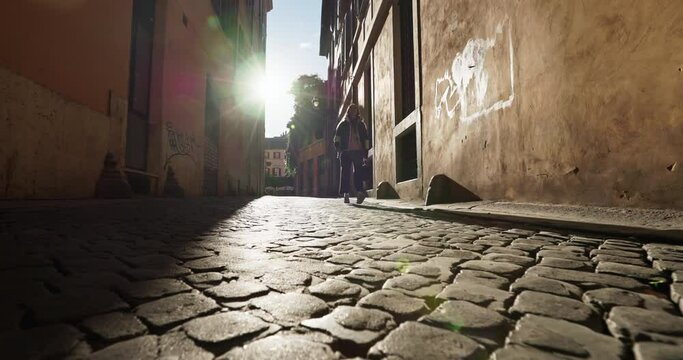 Beautiful streets of the capital of Italy, Rome. Beautiful sunset rays shine on the cobblestones in the historic district. High quality 4k footage