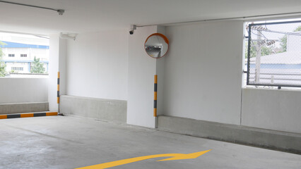 The curved glass with securit camera is installed at the corner of the parking building to prevent...