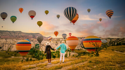 Cappadocia Turkey during sunrise, a couple mid age men and women on vacation in the hills of Goreme...
