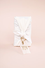 Christmas gift wrapped by traditional Japanese furoshiki style. Handmade gift package for Christmas.