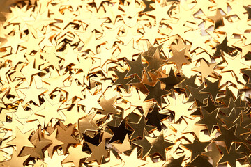 Abstract Christmas background with gold stars confetti.