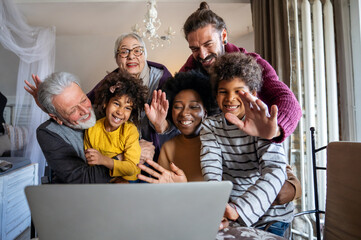 Extended multiethnic family together at home during video call. People happiness technology concept
