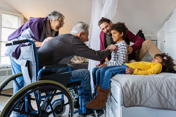 Three generational happy multiethnic diverse family having fun, enjoying time together at home