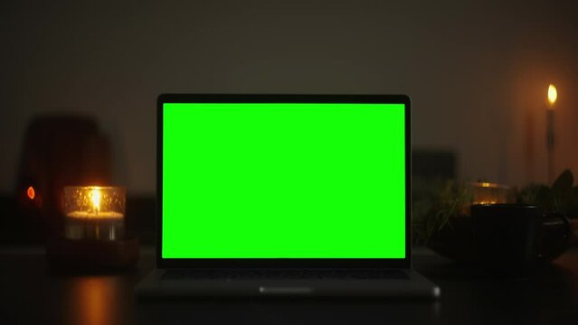 Immersive Stock Footage: Transform Your Video with a Green Screen Laptop and Festive Candlelight