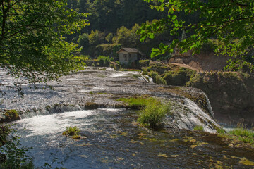 The River Una as it flows over the top of Strbacki Buk, a terraced waterfall on the border between...