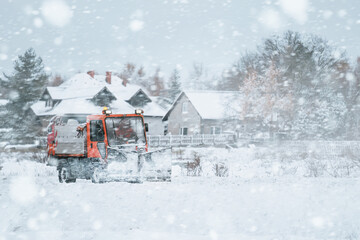 Tractor with mounted salt and sand spreader, road maintenance - winter gritter vehicle. Municipal...