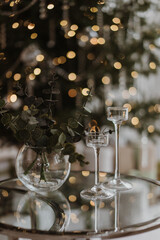 ceremonial glasses on the background of a New Year tree with garlands