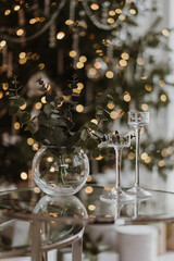 ceremonial glasses on the background of a New Year tree with garlands
