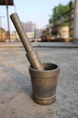 Bronze mortar and pestle for manual grinding of spices.