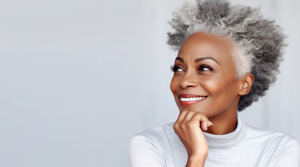 Beautiful adult black woman touch face with smooth healthy skin. Aging beautifully woman with curly gray hair and happy smiling. Beauty and cosmetics skincare advertising concept - obrazy, fototapety, plakaty