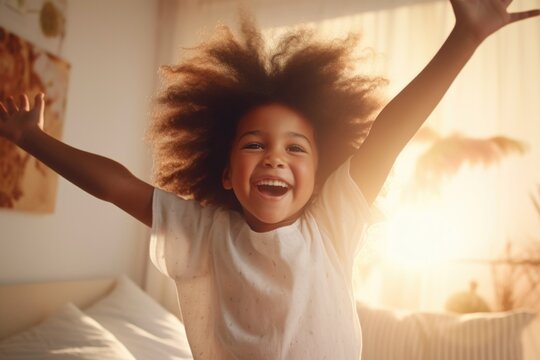 A playful image of a little girl jumping on a bed. Perfect for capturing the joy and energy of childhood. Ideal for use in advertisements, children's books, or parenting blogs