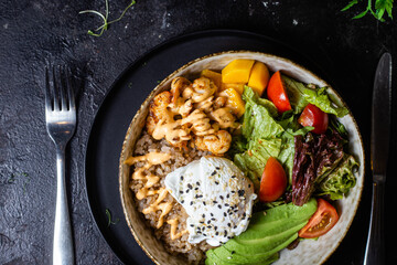 Breakfast in a plate. Poached egg with avocado and lettuce. 