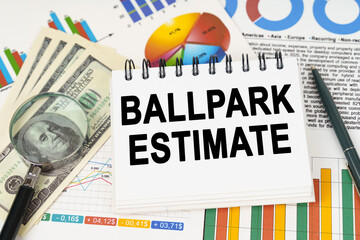 On the table are business charts, dollars and a notepad with the inscription - BALLPARK ESTIMATE