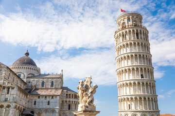 Pisa, Italy - Famous Leaning Tower landmark with blue sky, Renaissance white marble