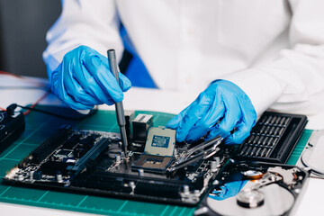 The technician repairing the motherboard in the lab with copy space. the concept of computer...