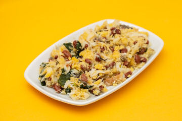 cod fish with corn bread, spinach and beans on dish