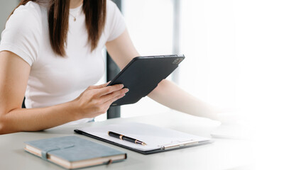 Fototapeta premium Businesswoman working on laptop, tablet and smartphone at her workplace at office..