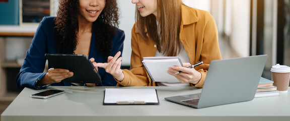 Happy businesspeople while collaborating on a new project in an office. two businesspeople using a...