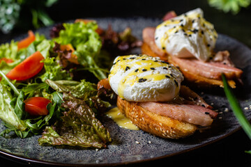 Toast with poached egg in a plate. Salad