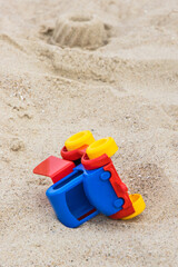 Fototapeta na wymiar Little car as toy for relax or playing on sand at beach. Vacation time