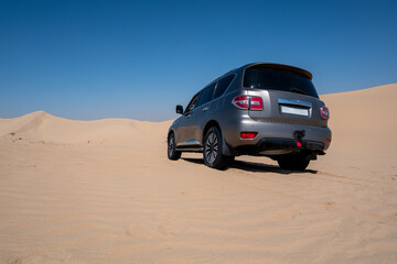 SUV four wheel drive vehicle car Al Qudra empty quarter seamless desert sahara in Dubai UAE middle...