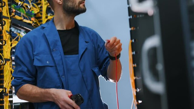 Server technician putting UTP cable into crimping pliers