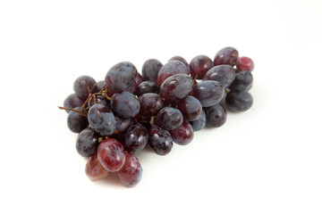 Bunch of organic black grapes isolated on white background.