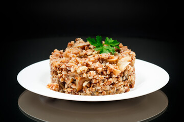 cooked buckwheat boiled with mushroom filling in a plate