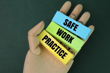 wooden hand and colored paper with the words safe work practices. the concept of work instructions