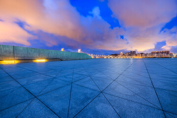 Empty square floors and Macau skyline with buildings at night