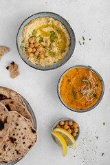 Different kinds of hummus. Traditional hummus and carrot hummus. Spread. Assorted meze and dips with crispy pita. Middle eastern snacks